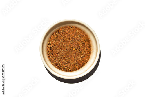 Saucer dish with ground cinnamon isolated on white background