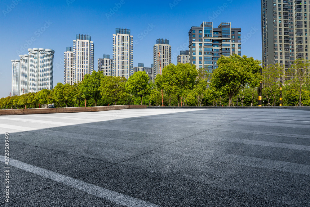 Panoramic skyline and modern business office buildings with empty road,empty concrete square floor Panoramic skyline and modern business office buildings with empty road,empty concrete square floor