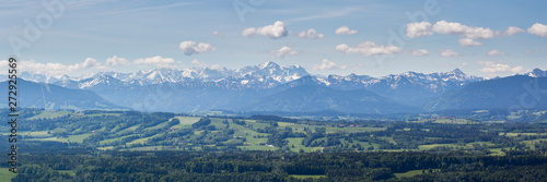 PEISSENBERG  BAVARIA   GERMANY - June 1  2019  Huge panorama view of the Wetterstein Mountain Range  part of the alps . Blue sky and white clouds. Bavarian forests in the foreground.