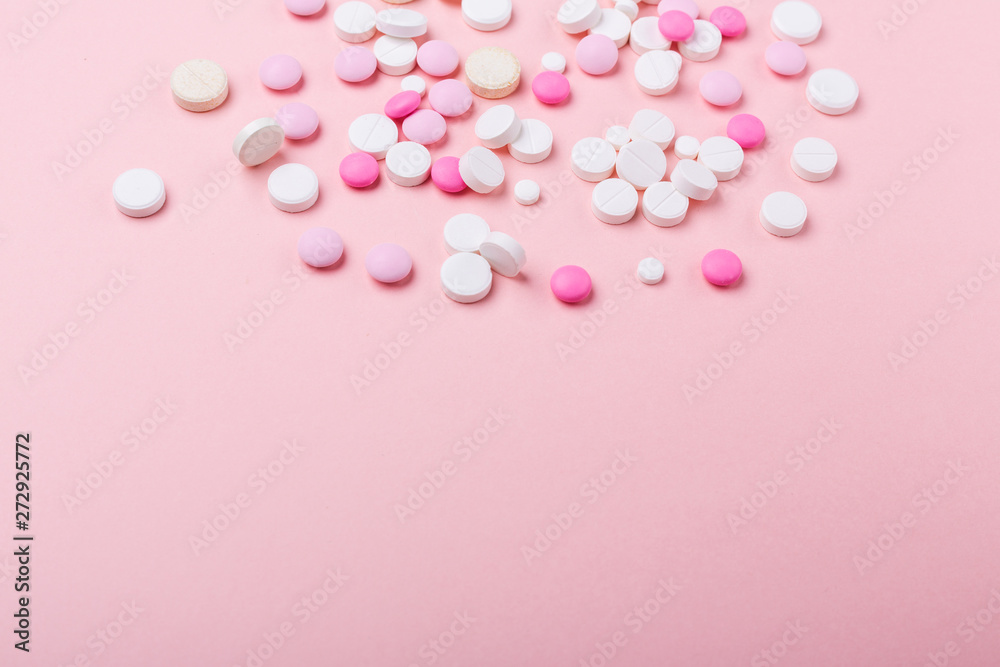 Pink and white pills on pink background. Heap of assorted various medicine tablets and pills. Health care. Copy space. Top view. Pink and white pills on pink background. Heap of assorted various medicine tablets and pills. Health care. Copy space. Top view.