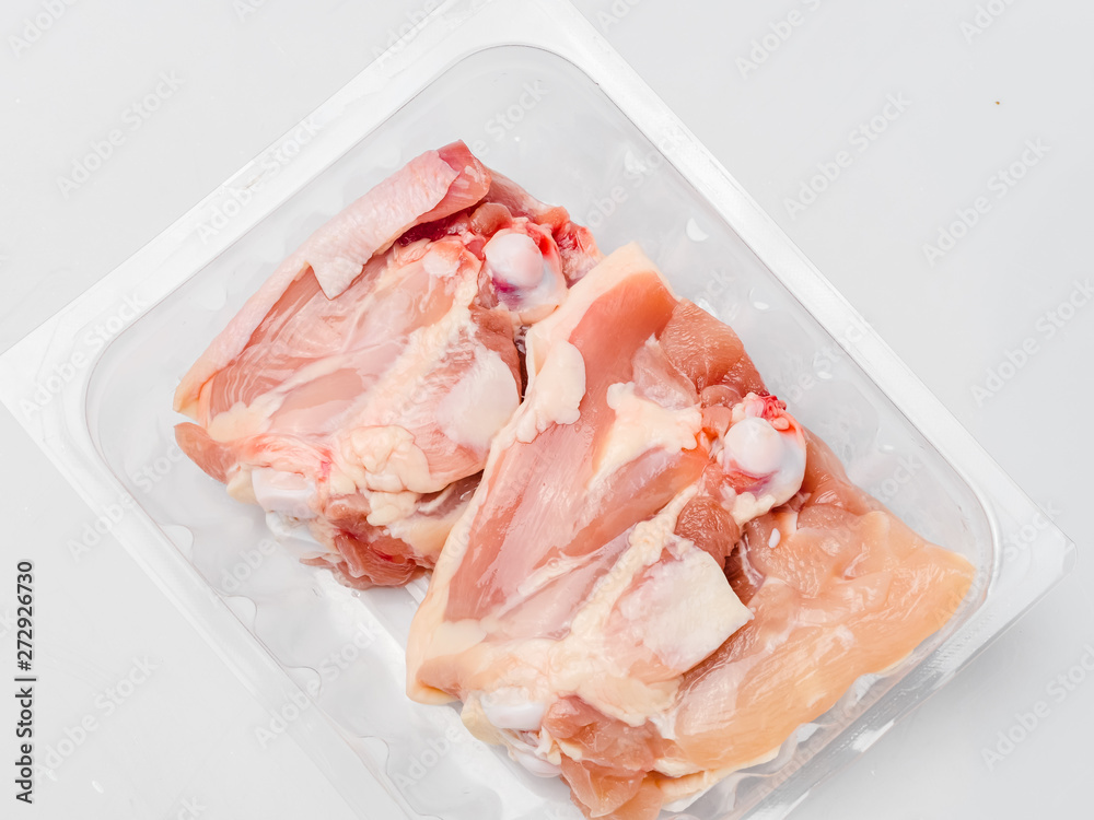 Chicken thighs in plastic pack from supermarket, ready to cook. Chicken thighs in plastic pack from supermarket, ready to cook.