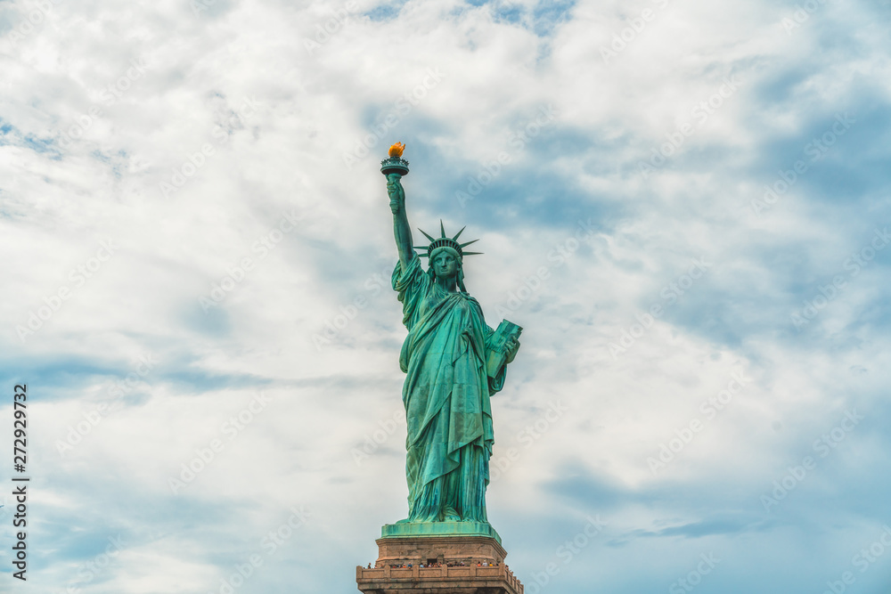 Fototapeta premium Statue Of Liberty, New York City Against Cloudy Blue Sky Background. Copy Space, Patriotism, Happy Forth of July, Independence Day, Travel Contest
