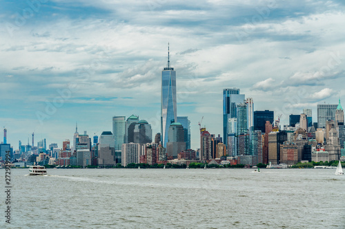 Hudson River  New York City Skyline with Manhattan Financial District and World Trade Center  Cloudy Blue Sky Background  NYC