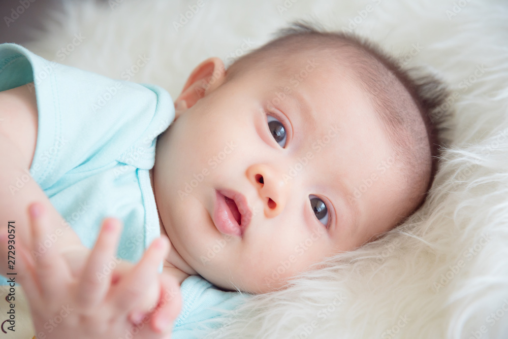Closeup shot of asian infant lying on bed Closeup shot of asian infant lying on bed