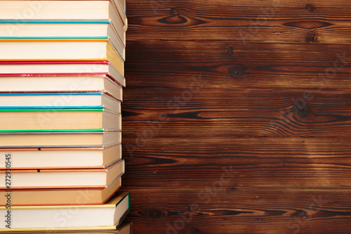 Stack of books on a wooden background.Education