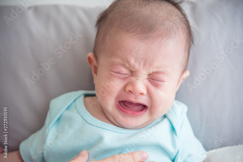 Foto Closeup shot of little asian infant crying