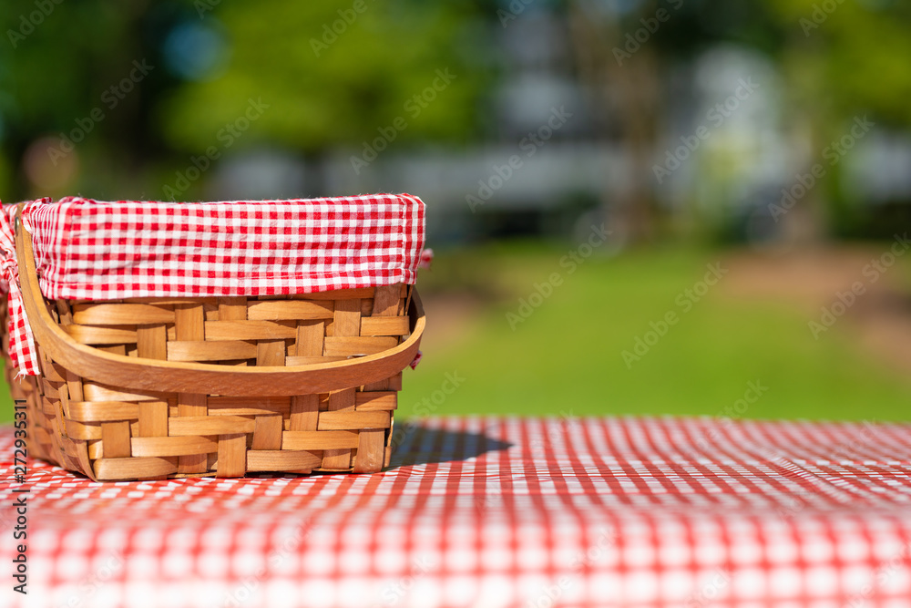 picnic basket on a table with a red tablecloth. Summer mood. relaxation. holidays picnic basket on a table with a red tablecloth. Summer mood. relaxation. holidays
