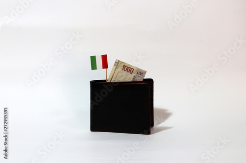 One thousand Lire of Italy banknote and mini Italia nation flag stick on the black wallet with white background. photo