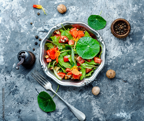 Salad with vegetables, nuts and nasturtium photo
