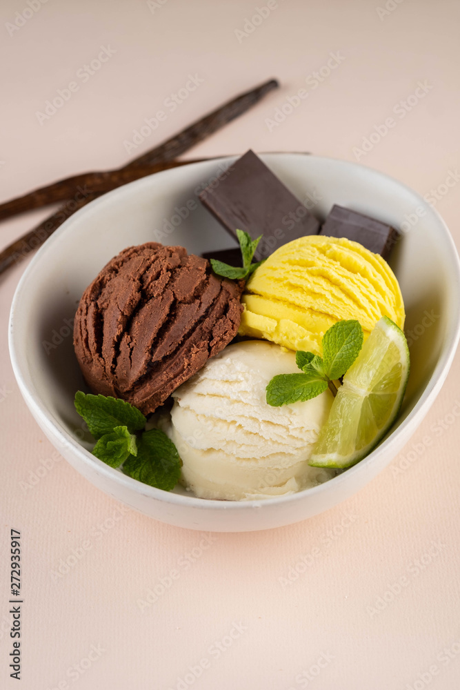 Trio of tasty chocolate vanilla and lime flavored frozen dessert in a white bowl. Trio of tasty chocolate vanilla and lime flavored frozen dessert in a white bowl.