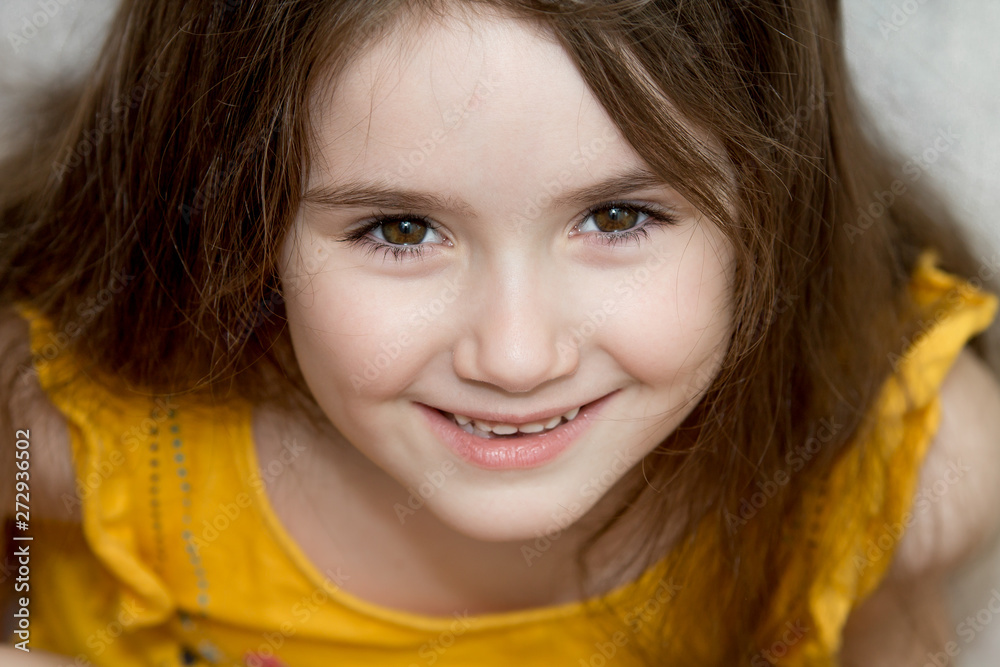the close up portrait of little girl's face with missing front lower milk teeth in a smiling mouth the close up portrait of little girl's face with missing front lower milk teeth in a smiling mouth