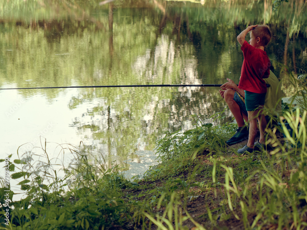 teen child catches a fishing rod on the pond. teen child catches a fishing rod on the pond.