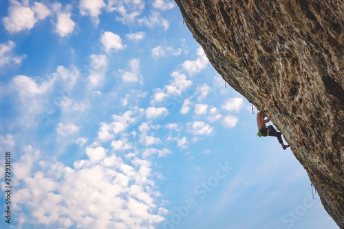 Man climbs rock.