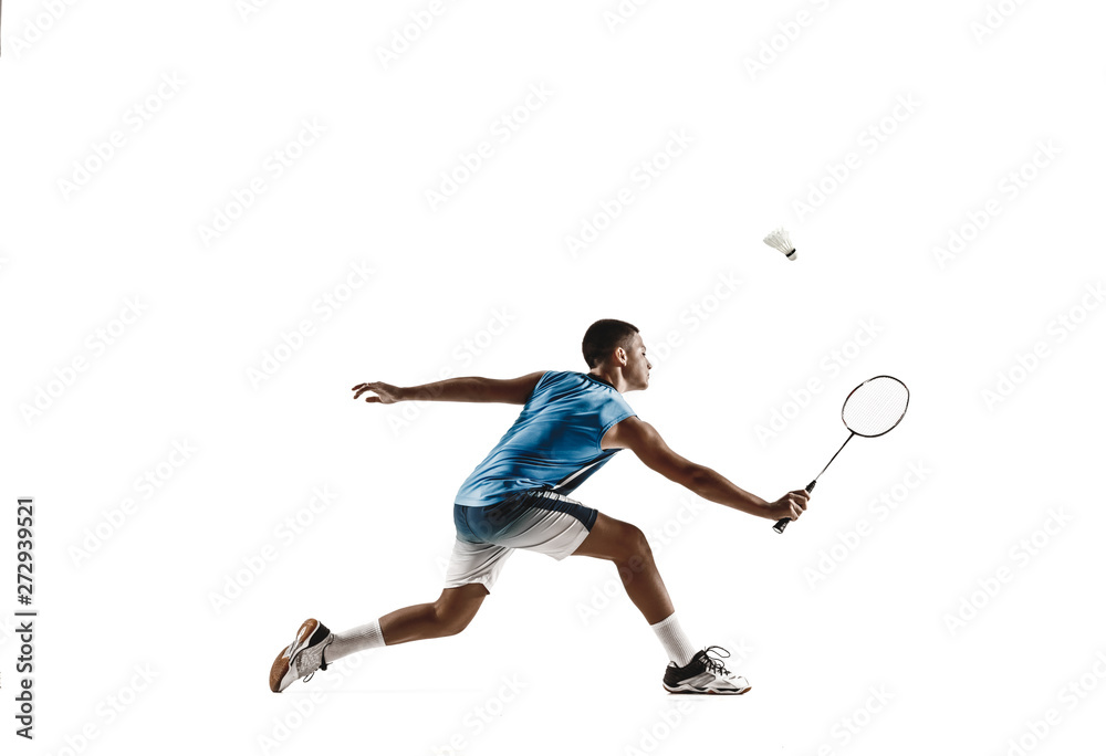 Little boy playing badminton isolated on white studio background. Young male model in sportwear and sneakers with the racket in action, motion in game. Concept of sport, movement, healthy lifestyle.