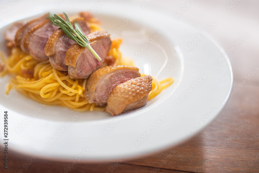 Pasta with meat on wooden table
Pasta with meat on wooden table