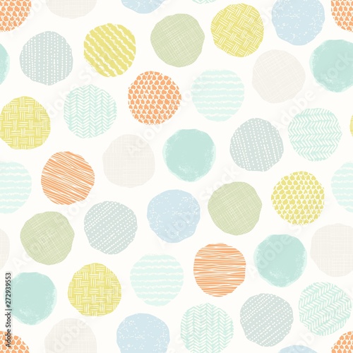 Abstract seamless pattern of scattered circles with hand drawn texture in pastel colors. Vector illustration in vintage style.