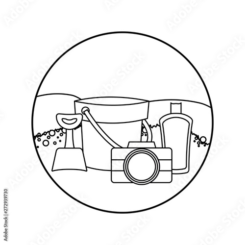 bucket with camera and bottle of blocker in beach