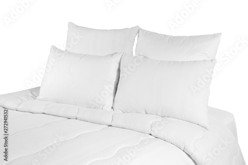 White coverlet or bedspread with four pillows isolated. White bedlinen on the bed.