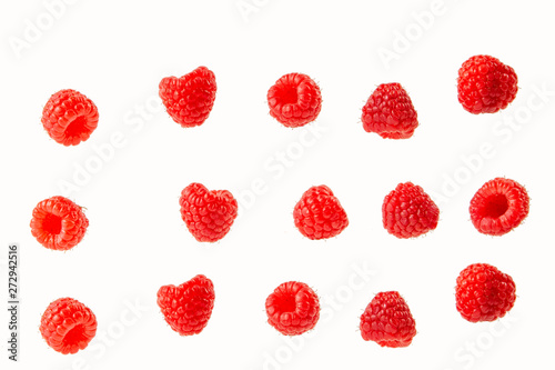 raspberry berries isolated on a white background in a chaotic manner .
