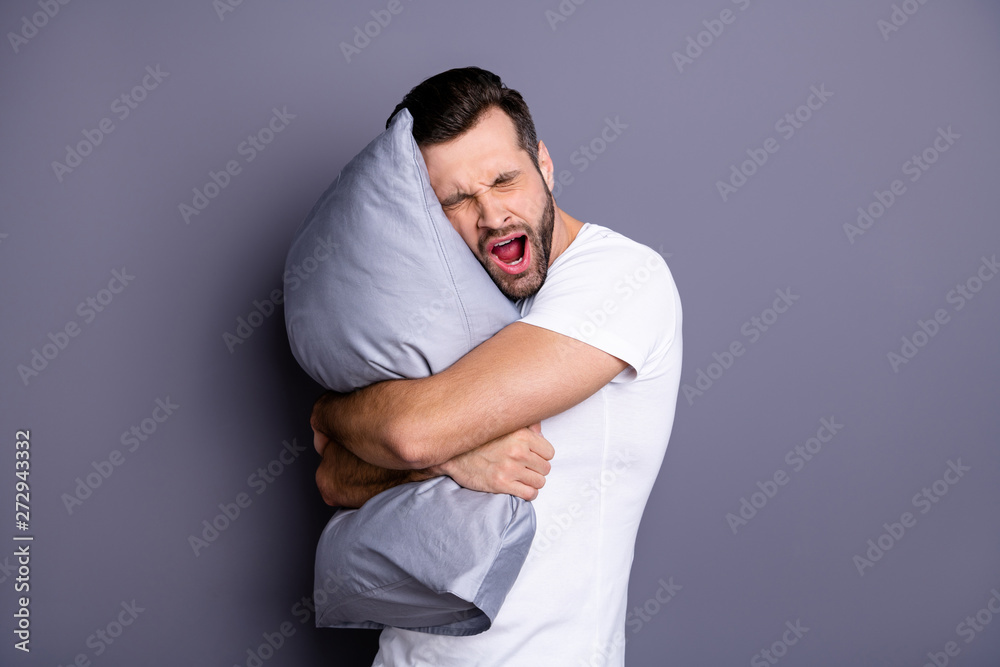 Portrait of his he nice-looking attractive bored tired sleepy bearded guy having rest chill out holding in hands pillow isolated over gray pastel violet purple background Portrait of his he nice-looking attractive bored tired sleepy bearded guy having rest chill out holding in hands pillow isolated over gray pastel violet purple background
