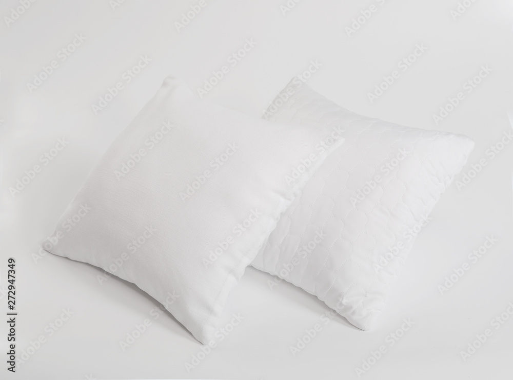 Fototapeta premium Two white pillows isolated, pillows on a white background, two pillows piled against white background