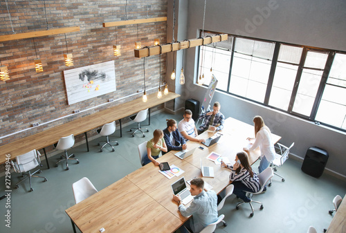 Young people having business meeting in modern office photo