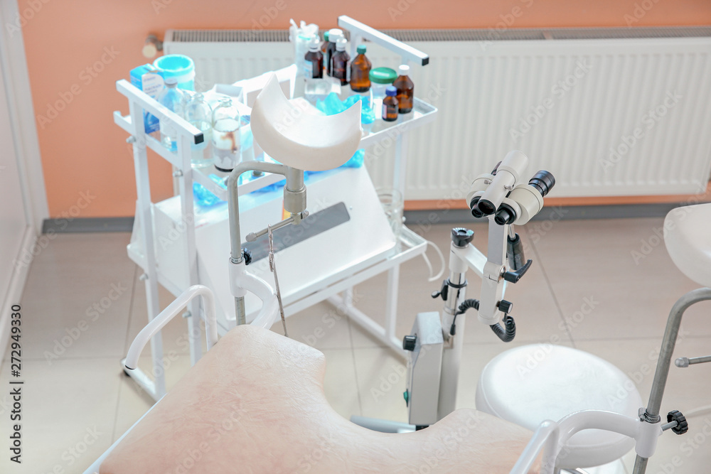 Gynecological chair with modern colposcope in clinic Gynecological chair with modern colposcope in clinic