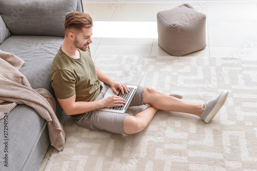 Handsome man with laptop re...