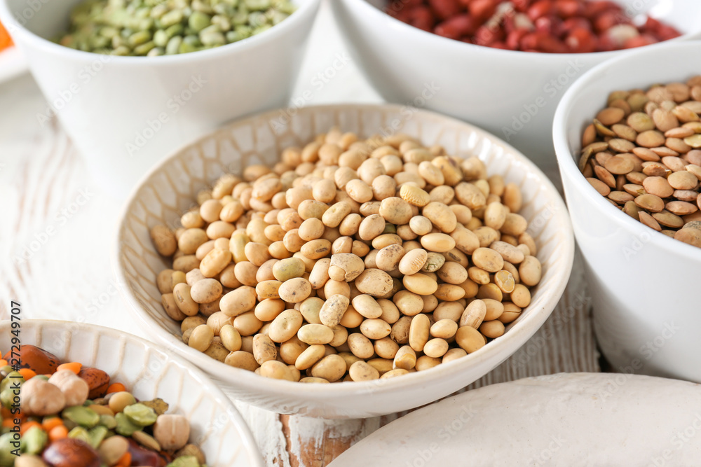 Assortment of legumes on white table Assortment of legumes on white table