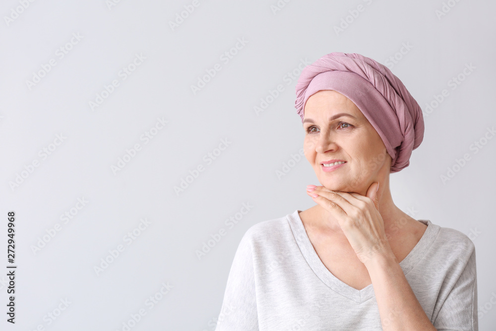 Mature woman after chemotherapy on light background Mature woman after chemotherapy on light background
