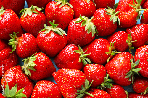Many ripe red strawberry as background