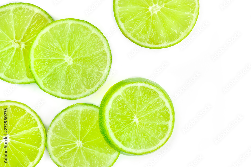 A closeup of vibrant lime slices, shot from the top on a white background with a place for text