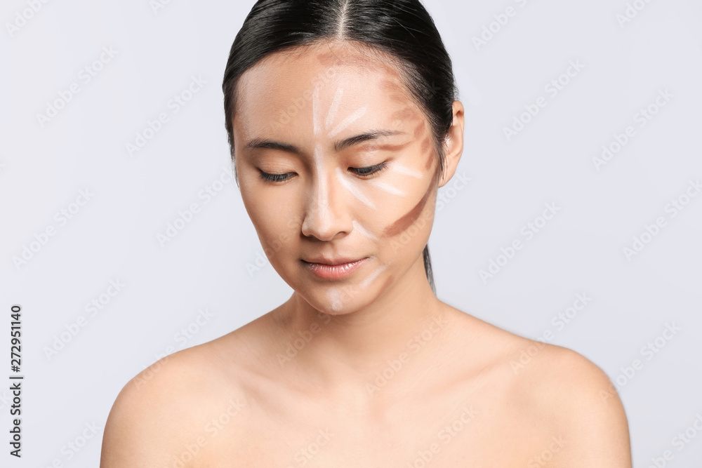 Asian woman with contouring makeup on light background Asian woman with contouring makeup on light background