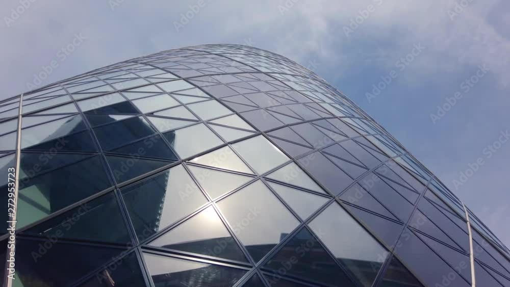 City office tower windows.  Camera moves around a city tower which has a all window facade.