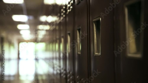 Red high school lockers, narrow hallway. photo
