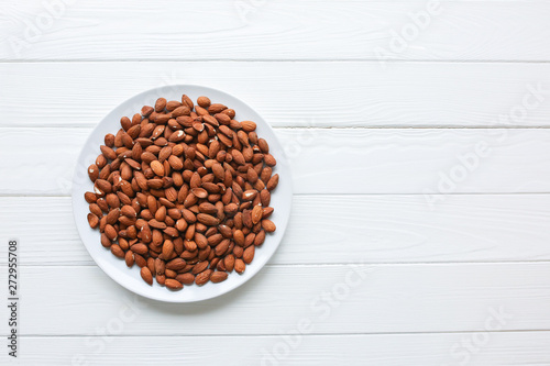 Almond lying on the plate. Healthy food. Vegan concept. Lifestyle. Nuts background. Copy space place.