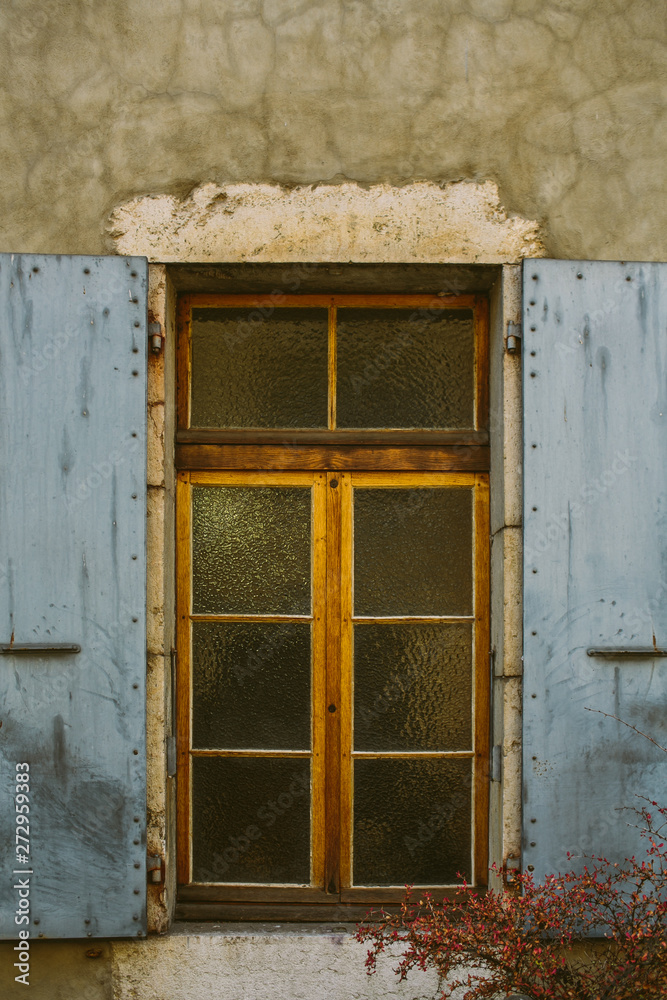 Old city scene: windows with vintage wooden shutters