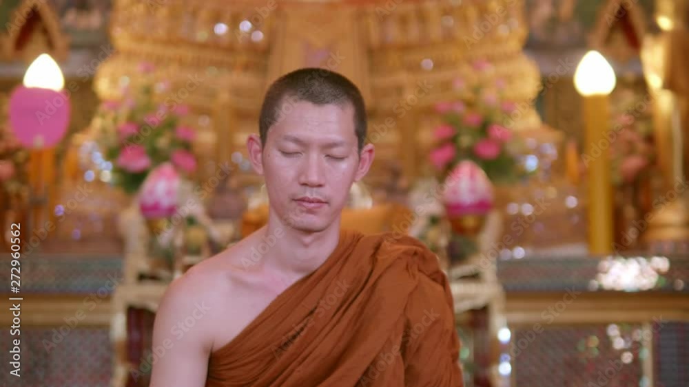 The monks were meditating in the church with calm and beautiful art and Buddha images. Slow motion. The monks were meditating in the church with calm and beautiful art and Buddha images. Slow motion.