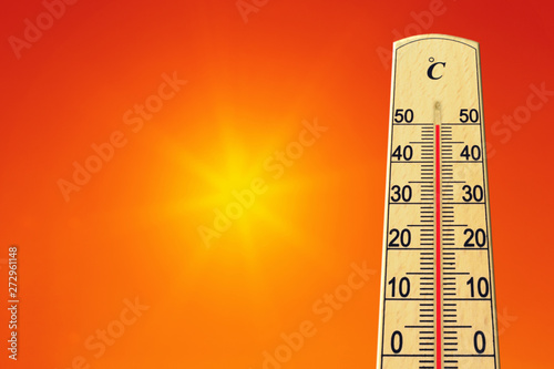 Yellow sun in red sky. Summer heat. Thermometer shows high temperature in summer. Ambient temperature plus 50 degrees