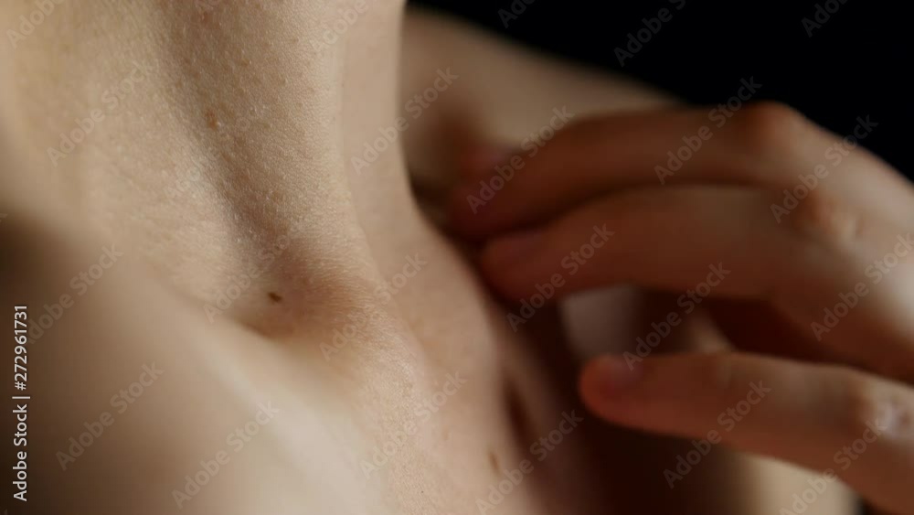 Person massages their collar bone.