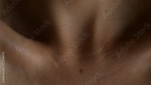 Person flexes their neck, moves collar bone.