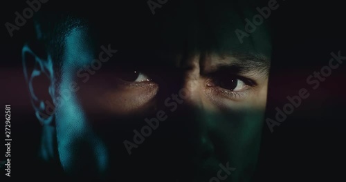 Angry man turns and looks in the camera as the light beam tightens (Anime style) 