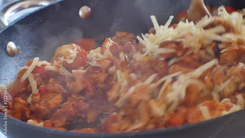Close up on hot steaming pan on cooker stove filled with red sauce covered nutritious vegetables, chicken & melting grated cheese mixture. Close up on hot steaming pan on cooker stove filled with red sauce covered nutritious vegetables, chicken & melting grated cheese mixture.