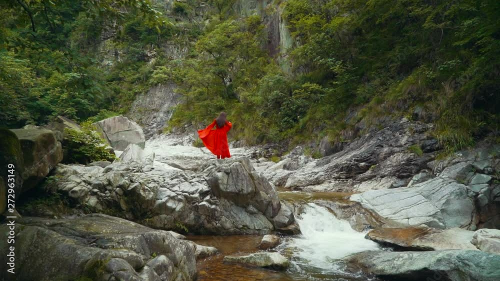 Ballerina dances in the breathtaking natural scenery. Slow motion classical dancing above a river, in the summer. Ballerina dances in the breathtaking natural scenery. Slow motion classical dancing above a river, in the summer.