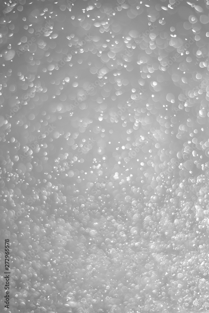 Bokeh background and bubbles reflecting black and white light