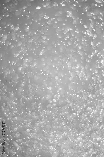 Bokeh background and bubbles reflecting black and white light