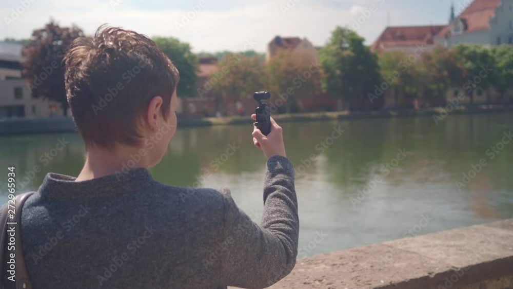 short hair woman makes movie in a German city with gimbal