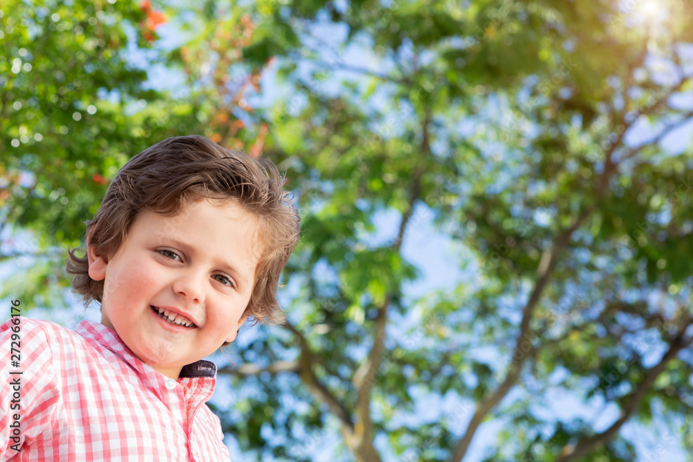 Happy child with pink shirt in the garden Happy child with pink shirt in the garden