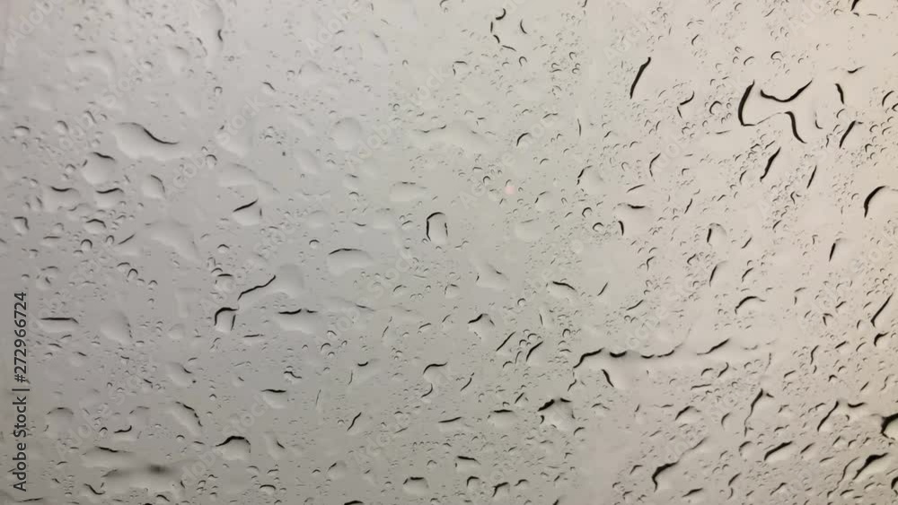 Water rain drops or steam shower on glass. Water droplets that increase the amount of movement Water rain drops or steam shower on glass. Water droplets that increase the amount of movement