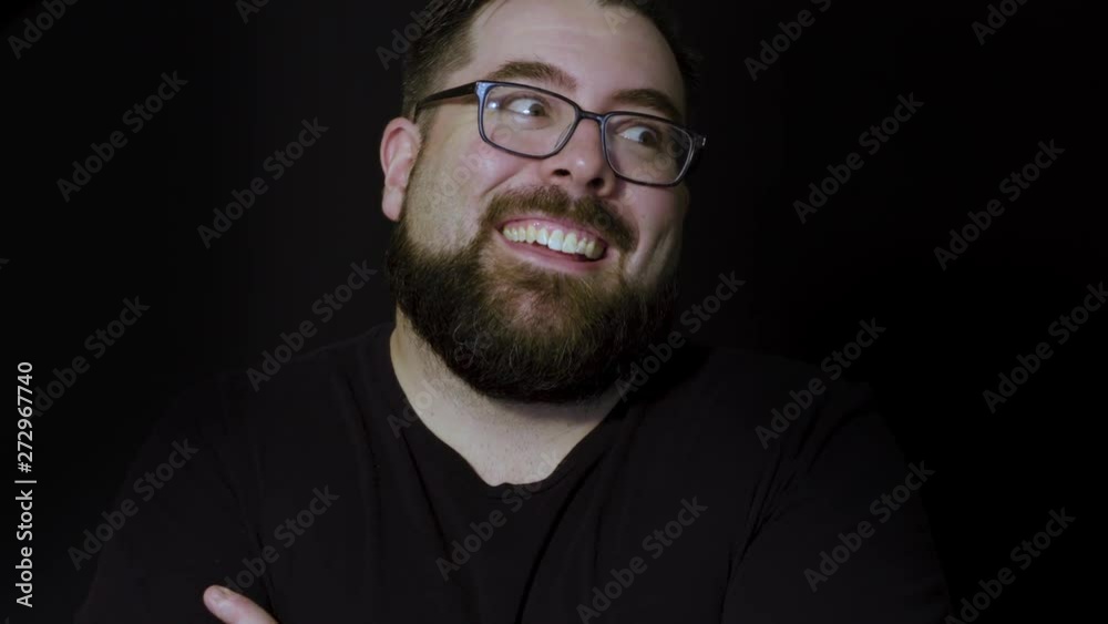 Motion studio portrait of a happy bearded man laughing Motion studio portrait of a happy bearded man laughing